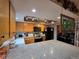 Bright kitchen showcasing granite countertops, wooden cabinets, and modern stainless steel appliances at 604 S Xenon Ct, Lakewood, CO 80228