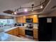 Updated kitchen with stainless steel appliances, granite countertops, and a modern track lighting system at 604 S Xenon Ct, Lakewood, CO 80228