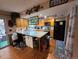 Bright kitchen featuring wood cabinets, granite countertops, and a kitchen island at 604 S Xenon Ct, Lakewood, CO 80228