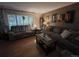 Inviting living room with comfortable seating, hardwood floors, and a large window at 604 S Xenon Ct, Lakewood, CO 80228