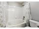 Clean bathroom with a shower/bathtub combination, white tile, and neutral-colored accessories at 8707 E Florida Ave # 814, Denver, CO 80247