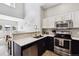 Contemporary kitchen featuring modern appliances, stylish backsplash, quartz countertop and an open plan view to the living room at 8707 E Florida Ave # 814, Denver, CO 80247