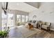 Bright living room with hardwood floors, natural light, and access to an outdoor balcony at 8707 E Florida Ave # 814, Denver, CO 80247