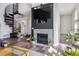 Comfortable living area with a fireplace, spiral staircase, and an abundance of natural light at 8707 E Florida Ave # 814, Denver, CO 80247