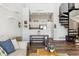 Bright living room featuring a modern spiral staircase and an open view to a kitchen with stainless steel appliances at 8707 E Florida Ave # 814, Denver, CO 80247