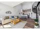 Bright, open-concept living room with hardwood floors, modern décor, and a unique spiral staircase at 8707 E Florida Ave # 814, Denver, CO 80247