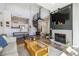 Stylish living room featuring a fireplace, dark wood accent wall, spiral staircase, and open flow to the kitchen at 8707 E Florida Ave # 814, Denver, CO 80247