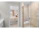 Bathroom features a glass shower and a view into the primary bedroom at 17115 W 91St Ln, Arvada, CO 80007