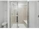 Bathroom features glass enclosed shower with bench, neutral tile and flooring at 17115 W 91St Ln, Arvada, CO 80007