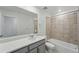 Bathroom features a shower over tub, tile surround, and a large mirror over the vanity at 17115 W 91St Ln, Arvada, CO 80007