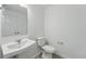 Bathroom features pedestal sink, toilet, and neutral paint at 17115 W 91St Ln, Arvada, CO 80007