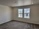 Cozy bedroom featuring plush carpeting and two bright windows overlooking the community at 17115 W 91St Ln, Arvada, CO 80007