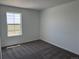 Bright bedroom with plush carpet and a large window with views of the neighborhood at 17115 W 91St Ln, Arvada, CO 80007