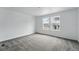Bedroom with gray carpet, two windows, and neutral paint at 17115 W 91St Ln, Arvada, CO 80007