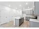 Bright kitchen with gray cabinets, stainless appliances, modern countertops and flooring at 17115 W 91St Ln, Arvada, CO 80007