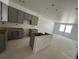 Large kitchen featuring stylish gray cabinets and an open floor plan at 17115 W 91St Ln, Arvada, CO 80007