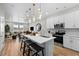Bright open kitchen with a center island, pendant lighting, stainless steel appliances and views to living room at 17115 W 91St Ln, Arvada, CO 80007