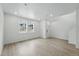Well lit living room with light wood floors and two bright windows at 17115 W 91St Ln, Arvada, CO 80007