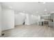 Open-concept living area with gray wood floors, recessed lighting, and a modern kitchen at 17115 W 91St Ln, Arvada, CO 80007