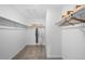 Walk-in closet with multiple shelves, rods, and overhead storage at 17115 W 91St Ln, Arvada, CO 80007