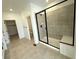Bathroom with a large glass shower and a bench at 3443 N Denali St, Aurora, CO 80019