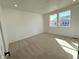 Bright and airy bedroom with neutral carpet, white walls, and large windows at 3443 N Denali St, Aurora, CO 80019
