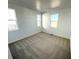 Bright and airy bedroom with neutral carpet, white walls, and large windows at 3443 N Denali St, Aurora, CO 80019
