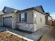 Beautiful single-Gathering home featuring stone accents, gray siding, and a two-car garage at 3443 N Denali St, Aurora, CO 80019