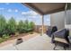 Relaxing back patio with a covered area, complete with stylish patio furniture, grill, and nice landscaping at 17409 Springfield Dr, Parker, CO 80134