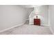 A carpeted basement area with stairs and a vintage cabinet, providing a flexible space at 17409 Springfield Dr, Parker, CO 80134