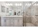 Modern bathroom featuring a double sink vanity, granite countertop, and tile shower at 17409 Springfield Dr, Parker, CO 80134