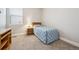 Cozy bedroom with a soft carpet, natural lighting, and a blue quilted bedspread at 17409 Springfield Dr, Parker, CO 80134