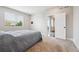 Bright bedroom includes carpet, large window, and access to a balcony at 17409 Springfield Dr, Parker, CO 80134