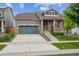 Charming home featuring a two-car garage, stone accents, and a cozy front porch with beautiful landscaping at 17409 Springfield Dr, Parker, CO 80134