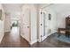 Elegant foyer featuring hardwood floors, white trim, and an open doorway to a home office at 17409 Springfield Dr, Parker, CO 80134