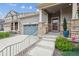 Inviting front porch with stone pillars and metal railings, leading to a well-maintained home entrance at 17409 Springfield Dr, Parker, CO 80134