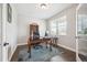 Well-lit home office with dark wood floors, ornate desk, and large window with natural light at 17409 Springfield Dr, Parker, CO 80134