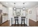 Bright, open kitchen with granite countertops, stainless appliances, and center island with bar seating at 17409 Springfield Dr, Parker, CO 80134