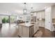 Spacious open-concept kitchen with a large center island and seamless flow to the living and dining areas at 17409 Springfield Dr, Parker, CO 80134