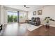 Open living room with wood floors, sliding glass doors, and stylish furnishings at 17409 Springfield Dr, Parker, CO 80134