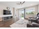 Bright living room boasts a large sliding glass door, wood floors, and a ceiling fan at 17409 Springfield Dr, Parker, CO 80134