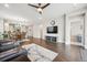 Spacious living room with wood floors, TV, and dining area in the background at 17409 Springfield Dr, Parker, CO 80134