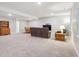 Spacious basement living room with large seating area, wooden cabinet, table, and a TV at 17409 Springfield Dr, Parker, CO 80134