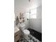 Bathroom featuring black fixtures, a patterned tile floor, subway tile, and glass enclosed shower at 215 E 11Th Ave # A5, Denver, CO 80203