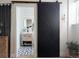 Bathroom view through sliding door featuring patterned tile floor, vanity with mirror and black faucet at 215 E 11Th Ave # A5, Denver, CO 80203