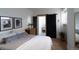 Cozy bedroom showcasing a sliding barn door leading to the bathroom with a patterned tile floor at 215 E 11Th Ave # A5, Denver, CO 80203