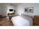 Bright bedroom featuring a seating area, TV, decor, and a comfortable bed with stylish bedding at 215 E 11Th Ave # A5, Denver, CO 80203