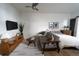 Bright and airy bedroom featuring a seating area, ceiling fan, and a comfortable bed with stylish decor at 215 E 11Th Ave # A5, Denver, CO 80203