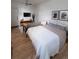 Bright bedroom with ceiling fan featuring a seating area, tv and comfortable bed with stylish bedding at 215 E 11Th Ave # A5, Denver, CO 80203