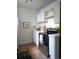 Bright kitchen with hardwood floors, white cabinets, and modern appliances at 215 E 11Th Ave # A5, Denver, CO 80203
